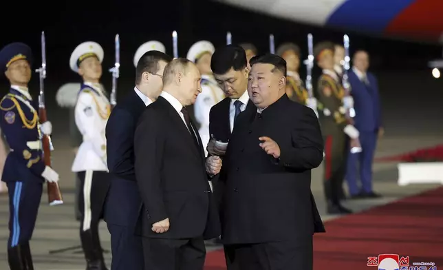 In this photo provided Wednesday, June 19, 2024, by the North Korean government, Russian President Vladimir Putin, center left, and North Korea's leader Kim Jong Un, center right, talk upon Putin's arrival at the Pyongyang International Airport in Pyongyang, North Korea, early Wednesday, June 19. The content of this image is as provided and cannot be independently verified. Korean language watermark on image as provided by source reads: "KCNA" which is the abbreviation for Korean Central News Agency. (Korean Central News Agency/Korea News Service via AP)