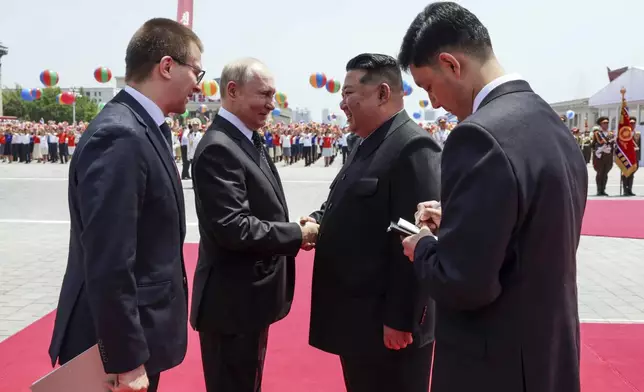 Russian President Vladimir Putin, second left, and North Korea's leader Kim Jong Un, second right, greet each other during the official welcome ceremony in the Kim Il Sung Square in Pyongyang, North Korea, on Wednesday, June 19, 2024. (Gavriil Grigorov, Sputnik, Kremlin Pool Photo via AP)