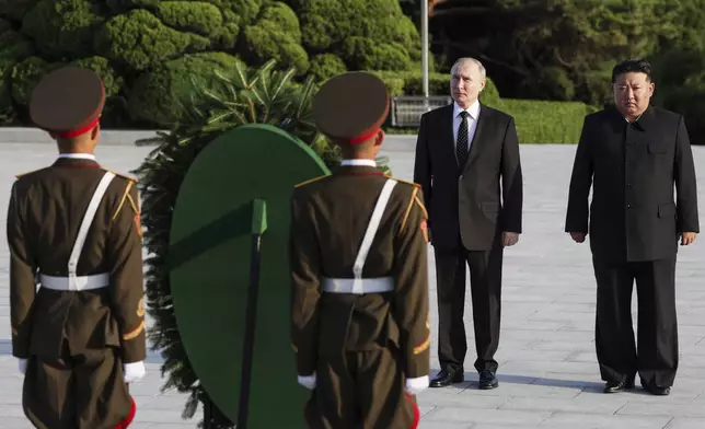 Russian President Vladimir Putin, second right, and North Korea's leader Kim Jong Un attend a wreath-laying ceremony at the Liberation Monument in Pyongyang, North Korea, on Wednesday, June 19, 2024. (Gavriil Grigorov, Sputnik, Kremlin Pool Photo via AP)