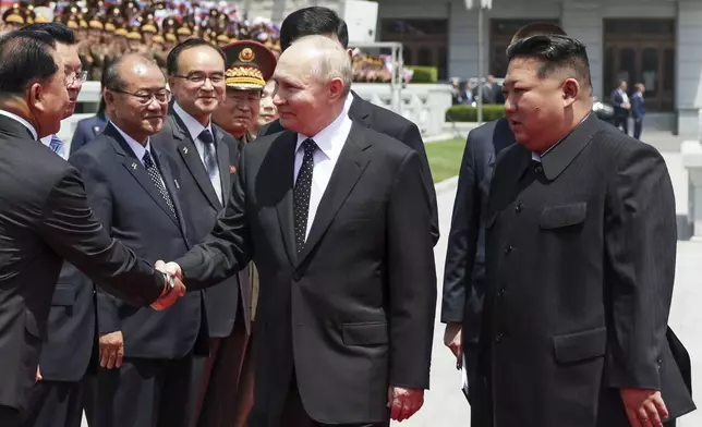 Russian President Vladimir Putin, center, and North Korea's leader Kim Jong Un, right, attend the official welcome ceremony in the Kim Il Sung Square in Pyongyang, North Korea, on Wednesday, June 19, 2024. (Gavriil Grigorov, Sputnik, Kremlin Pool Photo via AP)