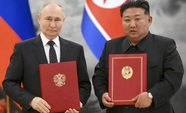 Russian President Vladimir Putin, left, and North Korea's leader Kim Jong Un pose for a photo during a signing ceremony of the new partnership in Pyongyang, North Korea, on Wednesday, June 19, 2024. Putin and North Korean leader Kim Jong Un signed a new partnership that includes a vow of mutual aid if either country is attacked, during a Wednesday summit that came as both face escalating standoffs with the West. (Kristina Kormilitsyna, Sputnik, Kremlin Pool Photo via AP)