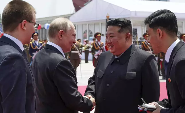 Russian President Vladimir Putin, second left, and North Korea's leader Kim Jong Un, second right, shake hands during the official welcome ceremony in the Kim Il Sung Square in Pyongyang, North Korea, on Wednesday, June 19, 2024. (Gavriil Grigorov, Sputnik, Kremlin Pool Photo via AP)