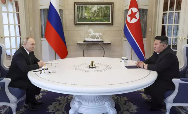 Russian President Vladimir Putin, left, and North Korea's leader Kim Jong Un talk to each other during their tete-a-tete meeting in Pyongyang, North Korea, on Wednesday, June 19, 2024. (Gavriil Grigorov, Sputnik, Kremlin Pool Photo via AP)