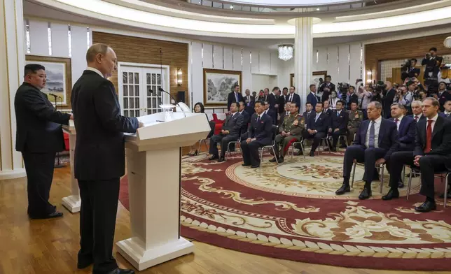 Russian President Vladimir Putin, foreground, and North Korea's leader Kim Jong Un, left, speak to the media after their talks in Pyongyang, North Korea, on Wednesday, June 19, 2024. (Gavriil Grigorov, Sputnik, Kremlin Pool Photo via AP)