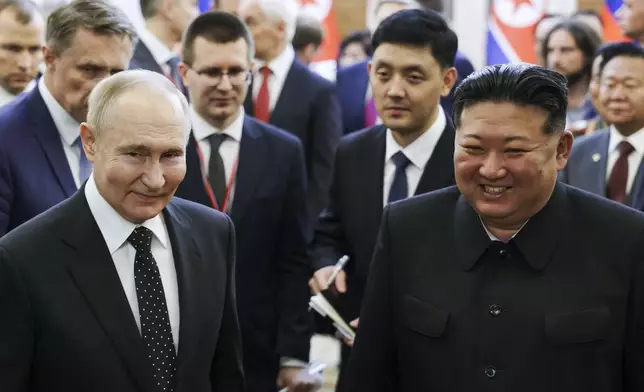 Russian President Vladimir Putin, left, and North Korea's leader Kim Jong Un smile as they walk after the talks in Pyongyang, North Korea, on Wednesday, June 19, 2024. (Gavriil Grigorov, Sputnik, Kremlin Pool Photo via AP)