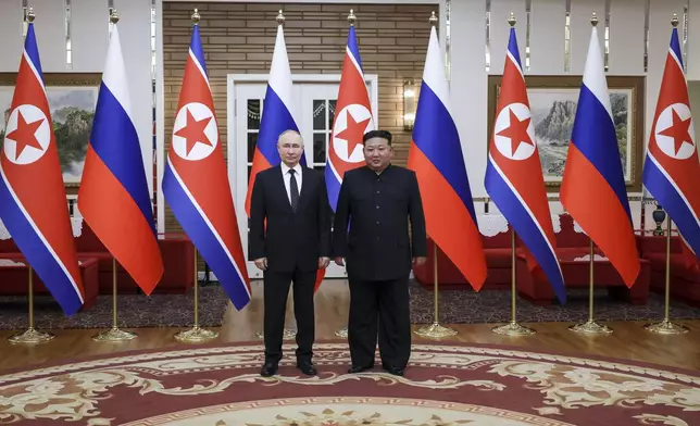 Russian President Vladimir Putin, left, and North Korea's leader Kim Jong Un pose for a photo after the official welcome ceremony in Pyongyang, North Korea, on Wednesday, June 19, 2024. (Vladimir Smirnov, Sputnik, Kremlin Pool Photo via AP)