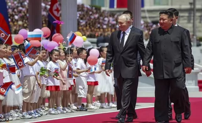 Russian President Vladimir Putin, left, and North Korea's leader Kim Jong Un, foreground right, attend the official welcome ceremony in the Kim Il Sung Square in Pyongyang, North Korea, on Wednesday, June 19, 2024. (Gavriil Grigorov, Sputnik, Kremlin Pool Photo via AP)