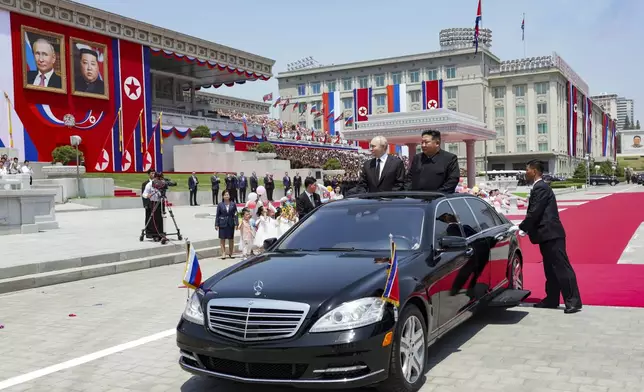 Russian President Vladimir Putin, left, and North Korea's leader Kim Jong Un, right, arrive to attend the official welcome ceremony in the Kim Il Sung Square in Pyongyang, North Korea, on Wednesday, June 19, 2024. (Gavriil Grigorov, Sputnik, Kremlin Pool Photo via AP)