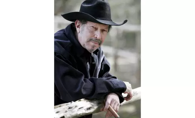 FILE - Musician and author Kinky Friedman smokes a cigar at his ranch near Medina, Texas, Friday, Jan. 21, 2005. Friedman, the singer, songwriter, satirist and novelist who also dabbled in Texas politics with a campaign for governor, died Thursday at his family’s Texas ranch near San Antonio. He was 79. (AP Photo/Eric Gay, File)