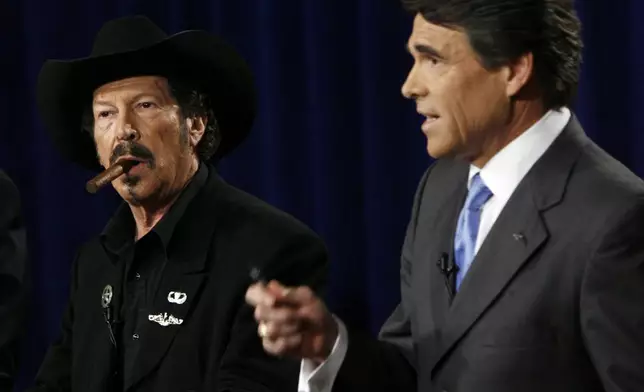 FILE - Texas gubernatorial candidate Kinky Friedman, left, listens as Gov. Rick Perry makes a comment during an on-air debate in Dallas on Oct. 6, 2006. Friedman, the singer, songwriter, satirist and novelist who also dabbled in Texas politics with a campaign for governor, died Thursday at his family’s Texas ranch near San Antonio. He was 79. (AP Photo/Smiley N. Pool, File)