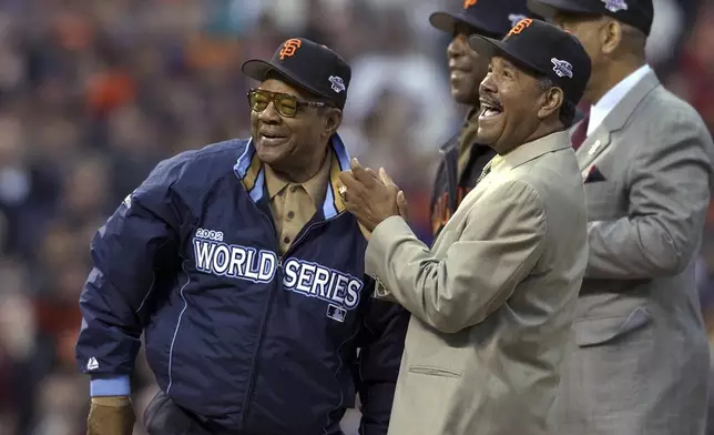 FILE - Willie Mays, left, is joined by former San Francisco Giants' Orlando Cepeda, right, Willie McCovey and Juan Marichal, front, before Game 3 of the World Series between the Giants and the Anaheim Angels in San Francisco,Oct. 22, 2002. Mays, the electrifying “Say Hey Kid” whose singular combination of talent, drive and exuberance made him one of baseball’s greatest and most beloved players, has died. He was 93. Mays' family and the San Francisco Giants jointly announced Tuesday night, June 18, 2024, he had “passed away peacefully” Tuesday afternoon surrounded by loved ones. (AP Photo/Kevork Djansezian, File)