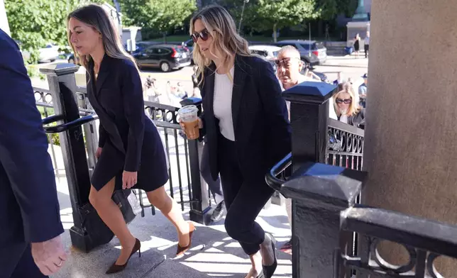 Karen Read, left, arrives with her defense team, including Elizabeth Little at right, at Norfolk Superior Court, Friday, June 28, 2024, in Dedham, Mass. Read, 44, is accused of running into her Boston police officer boyfriend with her SUV in the middle of a nor'easter and leaving him for dead after a night of heavy drinking. A jury is deliberating Read's fate, as her trial is nearing its end. (AP Photo/Charles Krupa)