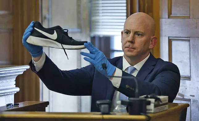 Massachusetts State Police Detective Lt. Brian Tully on the witness shows a sneaker found at Fairview Road that matches one taken of John O'Keefe at Good Samaritan hospital during the Karen Read murder trial, Wednesday, June 12, 2024, in Norfolk Super Court in Dedham, Mass. Read is facing charges, including second degree murder, in the 2022 death of her boyfriend Boston Officer John O’Keefe. (Greg Derr/The Patriot Ledger via AP, Pool)