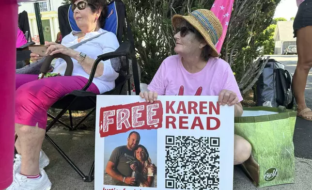 Supporters of Karen Read display signs near Norfolk Superior Court, Tuesday, June 25, 2024, in Dedham, Mass. Read is on trial, accused of killing her boyfriend Boston Police Officer John O'Keefe, in 2022. The jury began deliberations in the trial Tuesday. (AP Photo/Nick Perry)