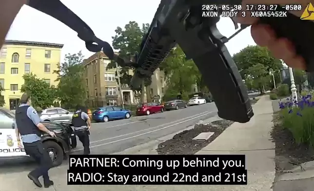 Frames from body-camera video released show officers responding to a shooting in which Minneapolis Police Officer Jamal Mitchell was killed along with three others, including the gunman, May 30, 2024, in Minneapolis, Minn. (Minneapolis Police Department via AP)