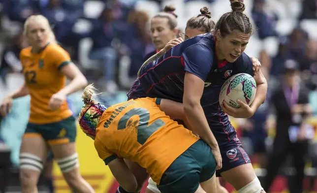 FILE - Ilona Maher of USA is tackled by Sharni Williams of Australia in a semifinal of the Rugby World Cup 7's championship held in Cape Town, South Africa, Sunday, Sept. 11, 2022. The main task for Maher, the breakout social media star on TikTok at the Tokyo Olympics, is winning a medal in Paris. (AP Photo/Halden Krog, File)