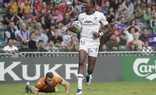 FILE - Perry Baker of the United States reacts after scoring a try against Australia during the second day of the Hong Kong Sevens rugby tournament in Hong Kong, Saturday, April 1, 2023. The US hasn't won an Olympic medal in rugby sevens since the sport was introduced in 2016. (AP Photo/Anthony Kwan, File)