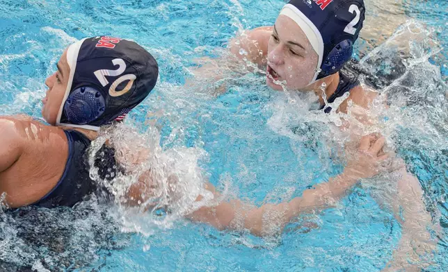 USA Water Polo Women's Senior National Team attacker Ryann Neushul, left, trains at Long Beach City College Thursday, Jan. 18, 2024, in Long Beach, Calif. Following in the footsteps of two older sisters who won gold with the U.S. women's water polo team, Ryann Neushul is making her Olympic debut in Paris this summer. (AP Photo/Damian Dovarganes)