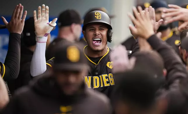 San Diego Padres' Manny Machado celebrates in the dugout after hitting a home run during the first inning of a baseball game against the Los Angeles Angels in Anaheim, Calif., Monday, June 3, 2024. (AP Photo/Ashley Landis)