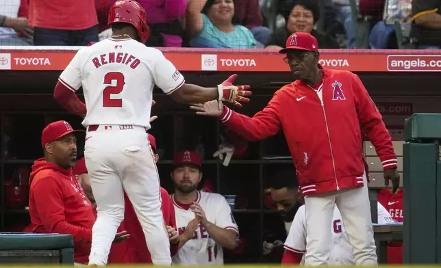 Los Angeles Angels' Luis Rengifo (2) returns to the dugout after scoring off of a single hit by designated hitter Willie Calhoun during the fourth inning of a baseball game against the San Diego Padres in Anaheim, Calif., Monday, June 3, 2024. (AP Photo/Ashley Landis)