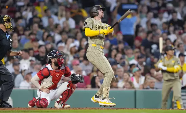 San Diego Padres' Jackson Merrill, front right, follows through on his three-run home run in front of Boston Red Sox catcher Connor Wong during the fifth inning of a baseball game, Friday, June 28. 2024, in Boston. (AP Photo/Michael Dwyer)