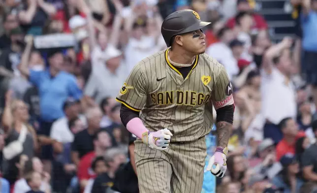 San Diego Padres' Manny Machado watches his two-run home run during the third inning of a baseball game against the Boston Red Sox, Saturday, June 29, 2024, in Boston. (AP Photo/Michael Dwyer)