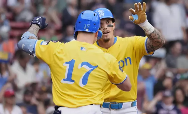 Boston Red Sox's Jarren Duran celebrates his solo home run with Tyler O'Neill (17) during the sixth inning of a baseball game against the San Diego Padres, Saturday, June 29, 2024, in Boston. (AP Photo/Michael Dwyer)