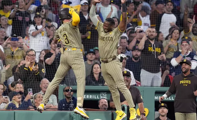 San Diego Padres' Jackson Merrill (3) celebrates after his three-run home run with Jurickson Profar, right, during the fifth inning of a baseball game against the Boston Red Sox, Friday, June 28. 2024, in Boston. (AP Photo/Michael Dwyer)