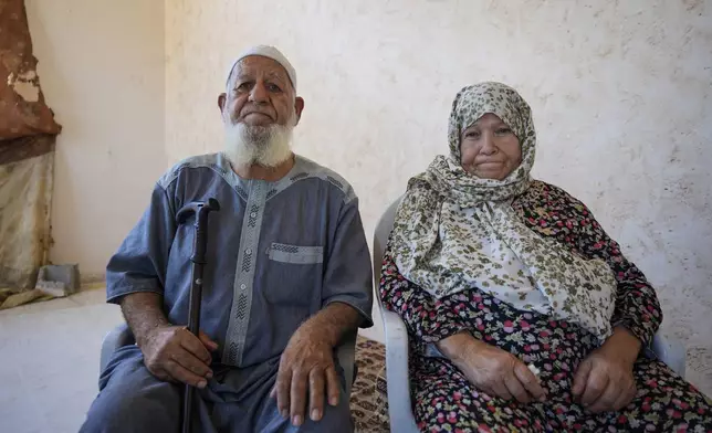 Abdel Haleem Abu Mutlaq, and his wife Amna Abu Mutlaq, pose for a portrait in Khan Younis, Gaza Strip, Wednesday, June 12, 2024. "We are deprived of (performing) Hajj because the crossing is closed, and because of the raging wars and destruction," said Amna Abu Mutlaq, a 75-year-old Palestinian woman from Gaza's southern city of Khan Younis who had planned to perform the Hajj pilgrimage this year. (AP Photo/Abdel Kareem Hana)