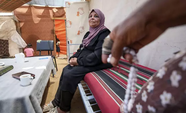 Ibrahim Abu Shaaban, right, sits with his wife in their tent on Thursday, June 13, 2024, in Deir al Balah, Gaza Strip. The couple had planned to perform the Hajj pilgrimage this year, but like all Palestinians in the coastal enclave of Gaza were not able to travel to Mecca because of the closure of the Rafah crossing in May when Israel extended its ground offensive to the strip's southern city of Rafah on the border with Egypt. (AP Photo/Abdel Kareem Hana)
