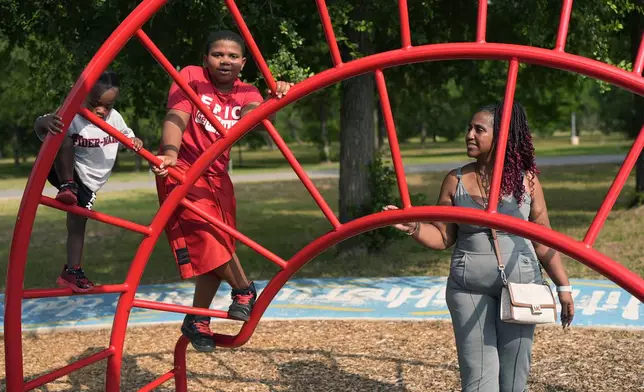 Tamika Davis, right, spends time with her children Lionel Jr., left, and Matthew, 11, at MLK Park in San Antonio, Thursday, May 30, 2024. Davis said friends and family watched her kids for most of her doctor visits during treatment last year for colon cancer. But she couldn't afford additional childcare, and she didn't know where to look for assistance. (AP Photo/Eric Gay)