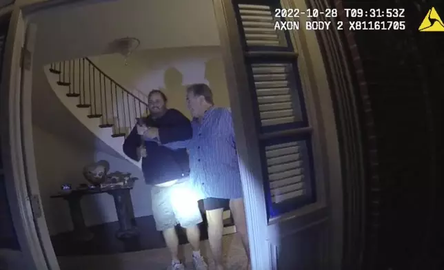 FILE - In this image taken from San Francisco Police Department body camera video, the husband of former U.S. House Speaker Nancy Pelosi, Paul Pelosi, right, fights for control of a hammer with his assailant, David DePape, during a brutal attack in the couple's San Francisco home, Oct. 28, 2022. DePape, who bludgeoned Nancy Pelosi’s husband with a hammer and was sentenced to 30 years in federal court, was also convicted Friday, June 21, 2024, of aggravated kidnapping by a state court which could put him behind bars for life. (San Francisco Police Department via AP, File)