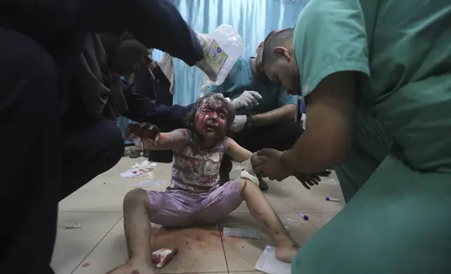 Palestinians wounded in the Israeli bombardment of the Gaza Strip arrive at al-Aqsa Hospital in Deir al-Balah, central Gaza Strip, Saturday, June 8, 2024. (AP Photo/Ismael Abu Dayyah)