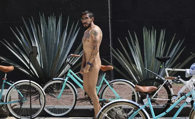 A cyclist attends World Naked Bike Ride day, in Mexico City, Saturday, June 8, 2024. Naked and partially clothed cyclists took to the streets in an effort to promote alternative forms of transportation highlighting the risks of the dependence on fossil fuels and climate change. (AP Photo/Ginnette Riquelme)