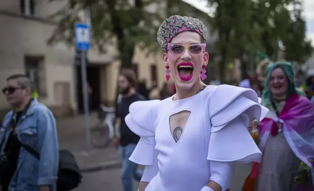 A reveler takes part in the Pride March in Vilnius, Lithuania, Saturday, June 8, 2024. (AP Photo/Mindaugas Kulbis)