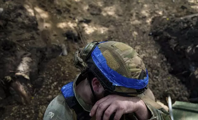 A Ukrainian national guard serviceman of Khartia brigade prepares to reload his D-20 cannon while firing towards Russian positions on the front line near Kharkiv, Ukraine, Monday, June 10, 2024. (AP Photo/Evgeniy Maloletka)