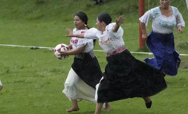 Sissa de la Cruz, left, and Sisa Guandinango, fight for the ball during a handball match in the Indigenous community of Turucu, Ecuador, June 14, 2024. (AP Photo/Dolores Ochoa)