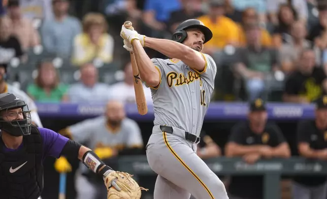 Pittsburgh Pirates' Bryan Reynolds watches his solo home run off Colorado Rockies starting pitcher Ryan Feltner during the first inning of a baseball game Friday, June 14, 2024, in Denver. (AP Photo/David Zalubowski)