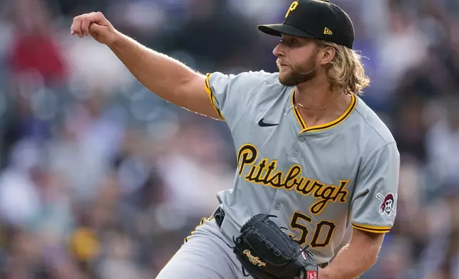 Pittsburgh Pirates starting pitcher Carmen Mlodzinski watches a throw to a Colorado Rockies batter during the first inning of a baseball game Friday, June 14, 2024, in Denver. (AP Photo/David Zalubowski)