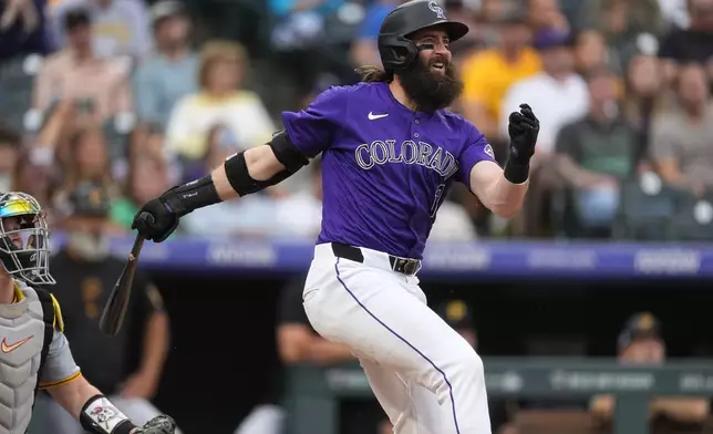 Colorado Rockies' Charlie Blackmon doubles against Pittsburgh Pirates relief pitcher Luis L. Ortiz in the third inning of a baseball game Friday, June 14, 2024, in Denver. (AP Photo/David Zalubowski)