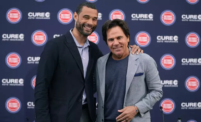 Detroit Pistons Owner Tom Gores, right, and President of Basketball Operations Trajan Langdon pose after addressing the NBA basketball media, Friday, June 21, 2024, in Detroit. (AP Photo/Carlos Osorio)