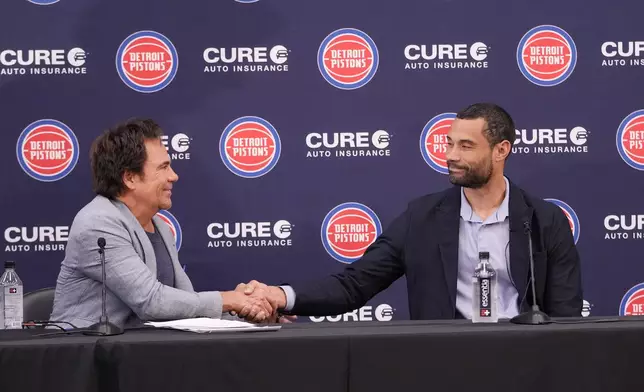 Detroit Pistons Owner Tom Gores, left, and President of Basketball Operations Trajan Langdon shake hands after addressing the NBA basketball media, Friday, June 21, 2024, in Detroit. (AP Photo/Carlos Osorio)