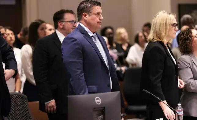 FILE - Auburn Police Officer Jeffrey Nelson, center, attends closing arguments in his trial, Thursday, June 20, 2024, at the Maleng Regional Justice Center in Kent, Wash. A jury found the suburban Seattle police officer guilty of murder Thursday, June 27, in the 2019 shooting death of a homeless man outside a convenience store, marking the first conviction under a Washington state law easing prosecution of law enforcement officers for on-duty killings. (Erika Schultz/The Seattle Times via AP, File)