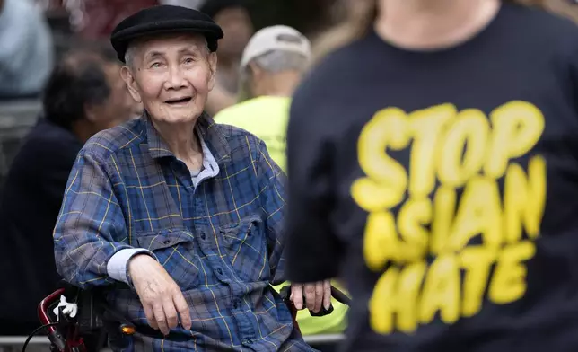 Li Zhou watches a remembrance ceremony for Vincent Chin in Chinatown, Sunday, June 23, 2024, in Boston. Over the weekend, vigils were held across the country to honor the memory of Chin, who was killed by two white men in 1982 in Detroit. (AP Photo/Michael Dwyer)