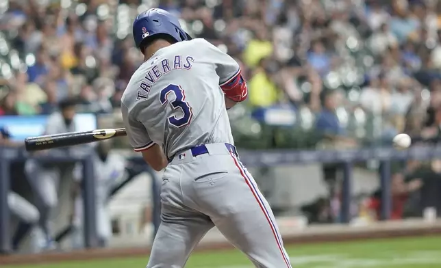 Texas Rangers' Leody Taveras hits a single during the sixth inning of a baseball game against the Milwaukee Brewers Tuesday, June 25, 2024, in Milwaukee. (AP Photo/Morry Gash)