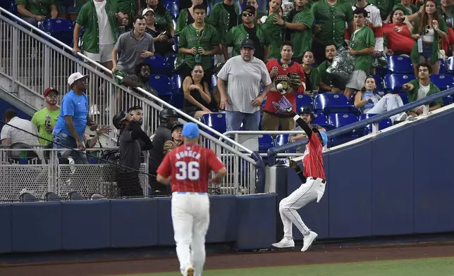 Miami Marlins outfielder Nick Gordon, right, catches a fly ball hit by Texas Rangers' Josh Smith (not shown) during the eighth inning of a baseball game, Saturday, June 1, 2024, in Miami. (AP Photo/Michael Laughlin)