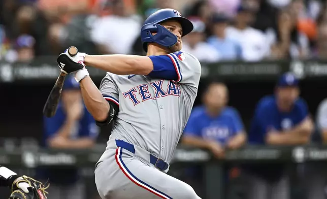 Texas Rangers' Corey Seager watches his solo home run off Baltimore Orioles pitcher Cade Povich during the first inning of a baseball game, Saturday, June 29, 2024, in Baltimore. (AP Photo/Terrance Williams)