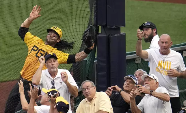 Pittsburgh Pirates right fielder Connor Joe, left, can't get to a foul ball hit by Tampa Bay Rays' Yandy Díaz during the fourth inning of a baseball game in Pittsburgh, Friday, June 21, 2024. (AP Photo/Gene J. Puskar)