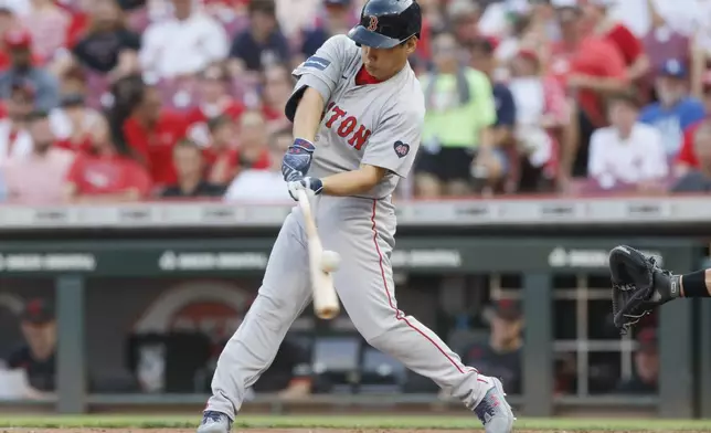 Boston Red Sox's Masataka Yoshida hits a foul tip against the Cincinnati Reds during the second inning of a baseball game Friday, June 21, 2024, in Cincinnati. (AP Photo/Jay LaPrete)