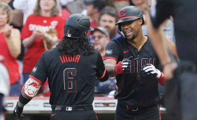 Cincinnati Reds' Jonathan India, left, celebrates his home run against the Boston Red Sox with Will Benson during the second inning of a baseball game Friday, June 21, 2024, in Cincinnati. (AP Photo/Jay LaPrete)